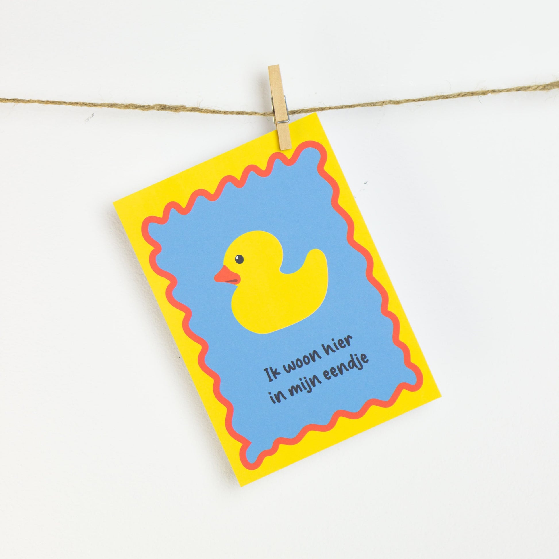Woordgrap op een print met eend: Ik woon hier in mijn eendje